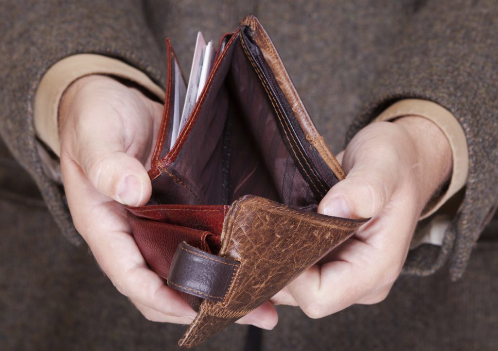 Businessman showing empty wallet. Finance and economy.