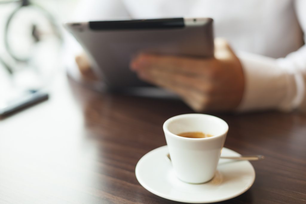 Man Reading News At Motning On Tablet Computer