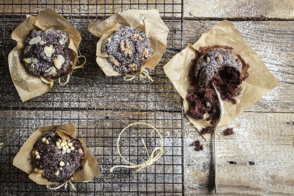 Closeup of tasting freshly baked chocolate muffins