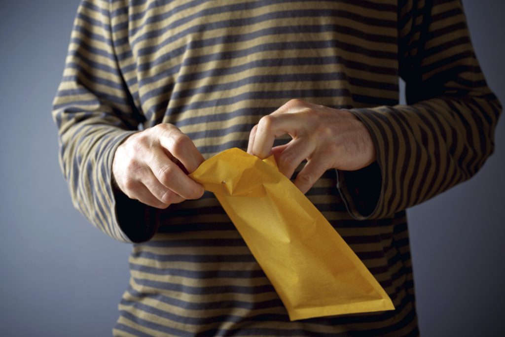 Man opening mail envelope