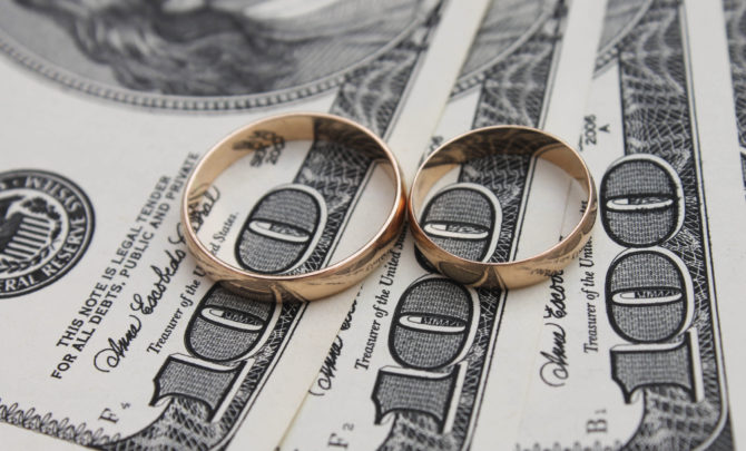 Wedding rings on the background of money