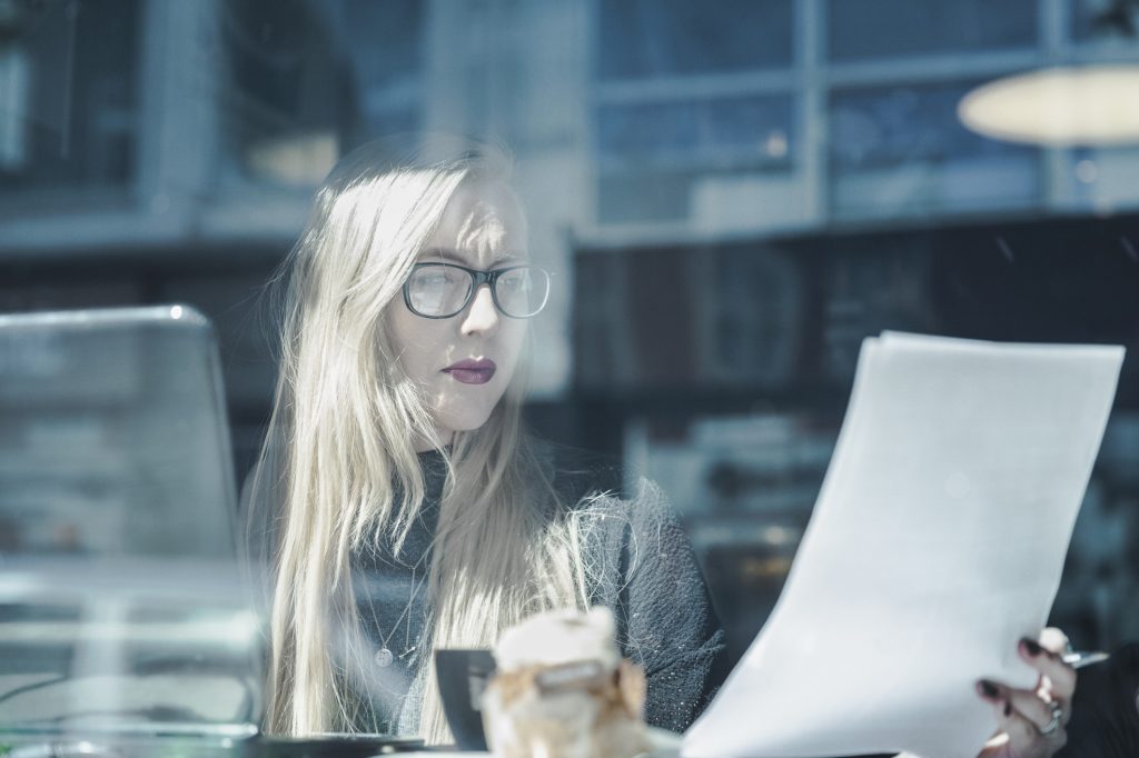 Businesswoman reading document in cafe